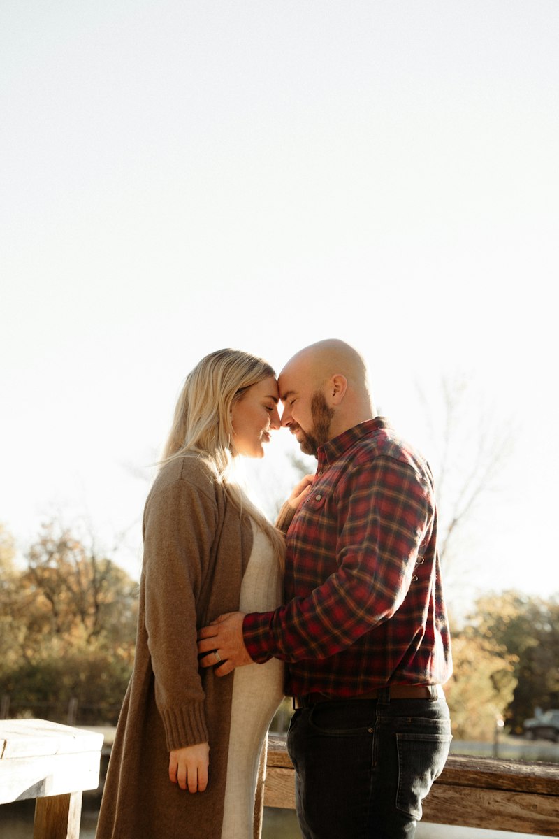 A man and woman standing next to each other in a quiet landscape