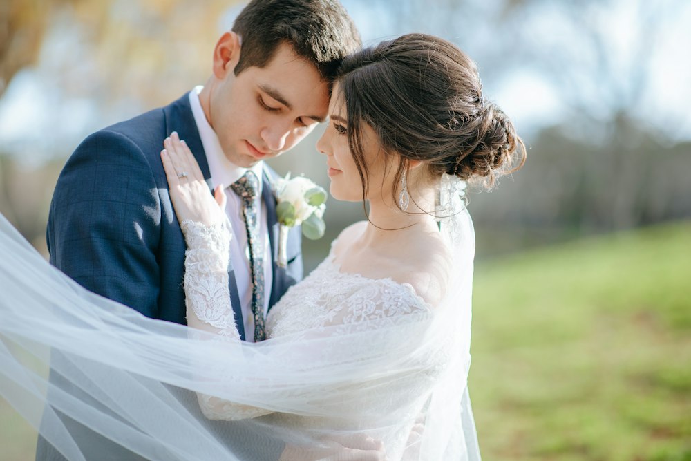 A man and woman sharing a kiss in soft natural light