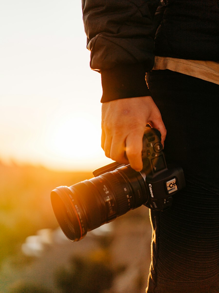A photographer holding a camera, ready to shoot