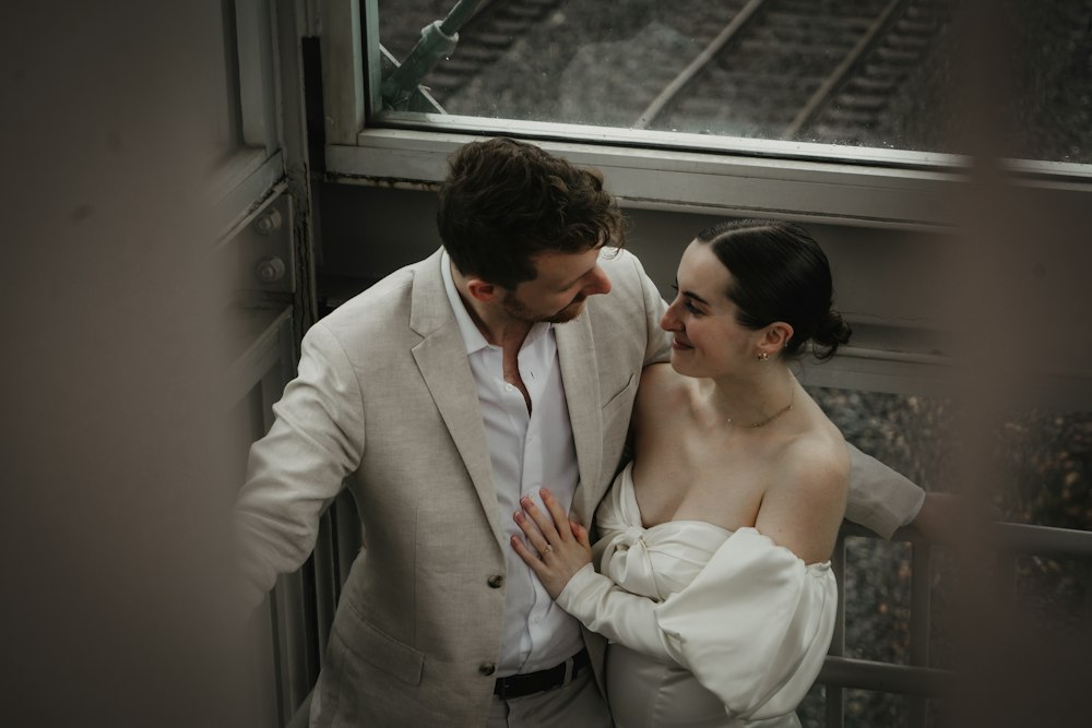 An engaged couple standing side by side during their portrait session